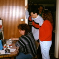 Endo sits at our single computer with a dial-up connection while Steve and Liza look on.