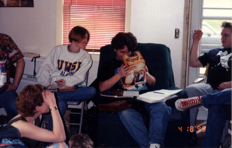 Gretchen, Glen and Jamie look on as Randy takes a break from his physics to examine a toy.