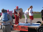 Alex gives Brad a hug before Brad hops onto the float.