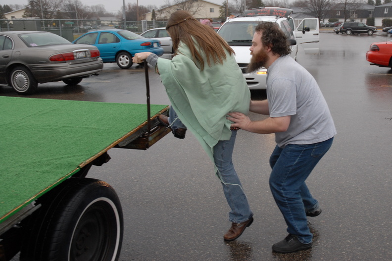 Pat thoughtfully helping his fiancee onto the float