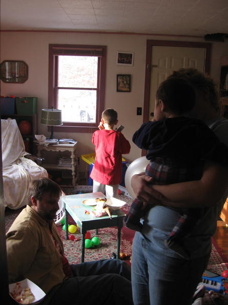 Brad on floor, Kate holding Issac, and Alex with ever present remote