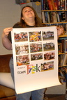 Joyce showing off a poster of team pictures